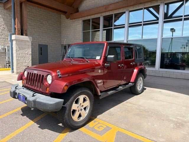 2007 Jeep Wrangler Unlimited Sahara in Ruby Red — front three-quarter view